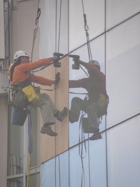 Pose de panneau bois en attente de vitrage travaux en hauteur sur cordes